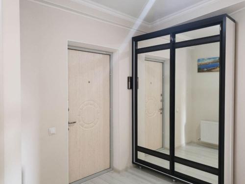 um espelho num quarto ao lado de uma porta em Lovely central 1BR apartment with a balcony em Chisinau
