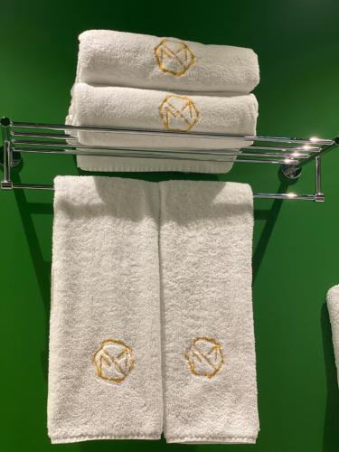 a group of towels on a towel rack at Molokan Inn Hotel in Baku