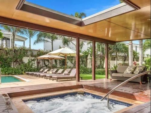 an outdoor pool with a hot tub in a house at Peppers Balé Luxury Beach Accommodation Kingscliff - privately let in Kingscliff