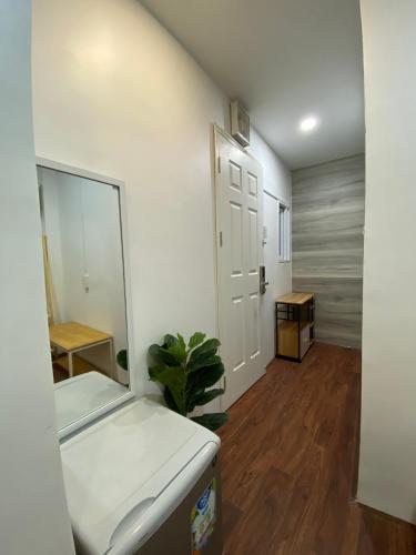 an empty room with a mirror and a room with a door at B-HOMEAWAY in Ho Chi Minh City