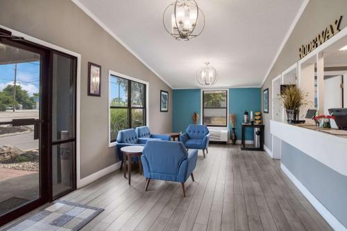a waiting room with blue chairs and a table at Rodeway Inn Carlisle North in Carlisle