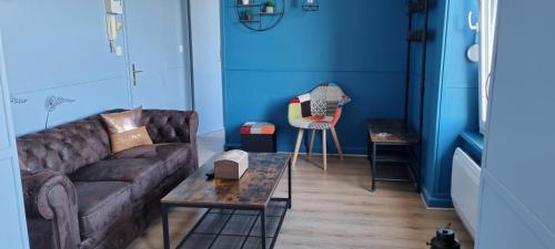 a living room with a couch and a table at L'AUBERGADE in Vittel