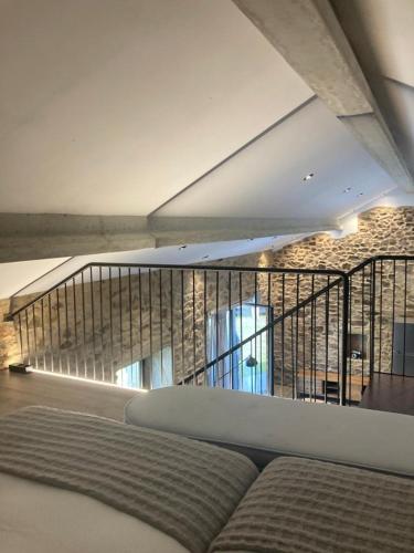 a room with a bed and a balcony at Casa María da Retratista in Muxia