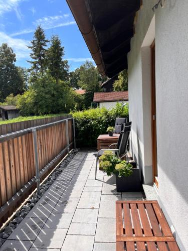 a balcony with a bench and a table and chairs at Ferienhaus Schwangau in Schwangau
