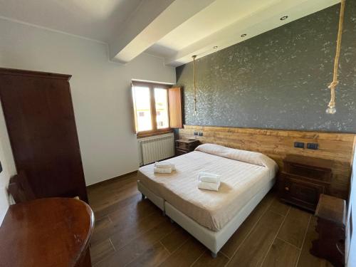 a bedroom with a bed and a chalkboard on the wall at Agriturismo Cupello in Cagnano Amiterno