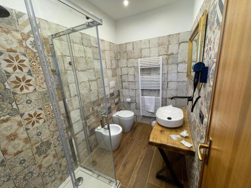a bathroom with two toilets and a glass shower at Agriturismo Cupello in Cagnano Amiterno