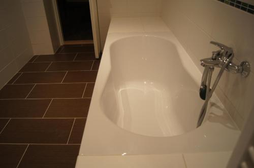 a bath tub with a faucet in a bathroom at Apartmany Ostrava in Ostrava