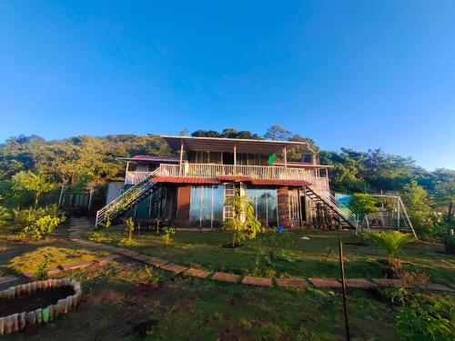 a house in the middle of a field at Forrest Homestay Villa in Bhor
