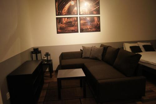 a living room with a couch and a bed at Apartmany Ostrava in Ostrava