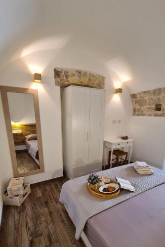 a bedroom with a large mirror and a bed at Bobboi in Cagliari