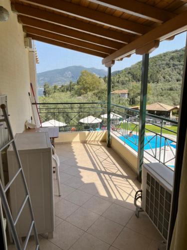 a balcony with a view of a swimming pool at Villa Agni in Yénion