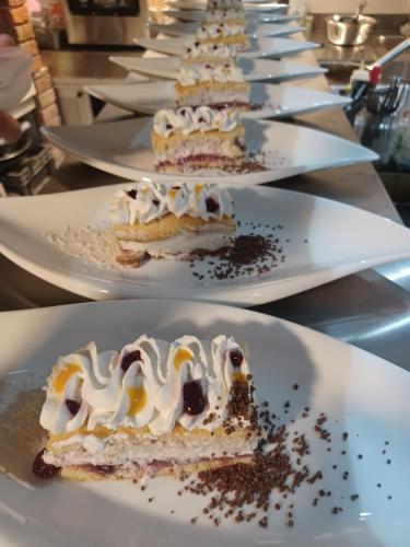 a row of white plates with desserts on them at Wellness Villa Istriana in Umag