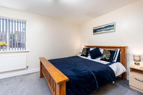 a bedroom with a large bed and a window at Boulevard View in Doncaster