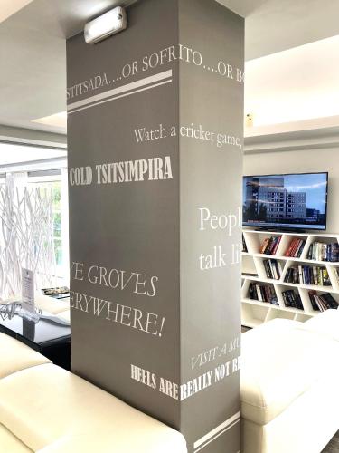 a living room with a wall with words on it at TRYP by Wyndham Corfu Dassia in Dassia