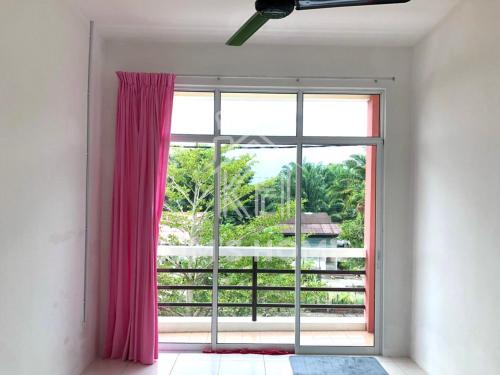 a room with a large window with pink curtains at Kim’s Home - Homey At Your Stay in Nibung Tebal