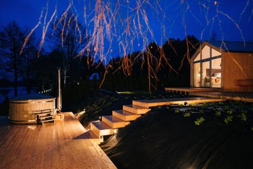 a house with stairs leading to a yard at night at Promowa17 in Rogóźno