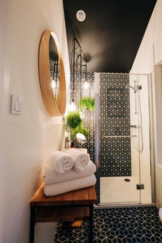 a bathroom with a shower with towels on a table at Promowa17 in Rogóźno