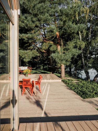 a wooden deck with a table and chairs on it at Promowa17 in Rogóźno