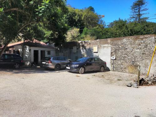 two cars parked in front of a house at Quinta Das Murtas B&B in Sintra