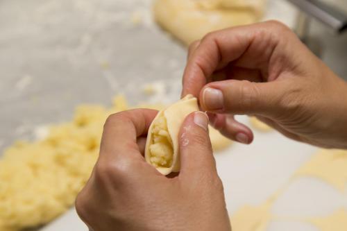 a person holding a piece of food in their hands at Hotel Grillo in Nuoro