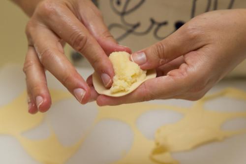 a person holding a piece of food in their hands at Hotel Grillo in Nuoro