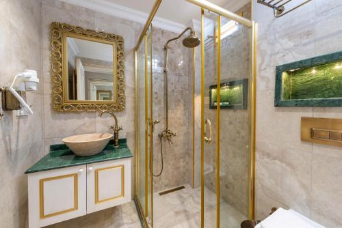 a bathroom with a sink and a shower at Begonville Mansion Oldcity in Istanbul