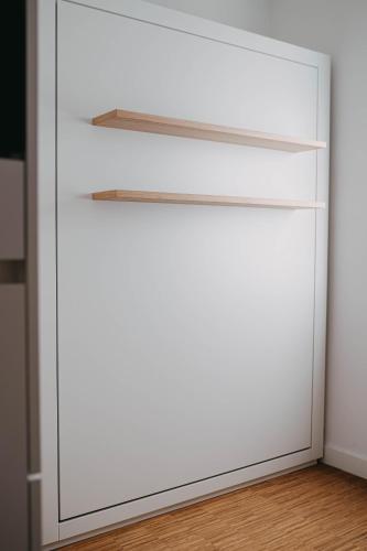 a white closet door with a light on top at Maximilian Studios in Speyer