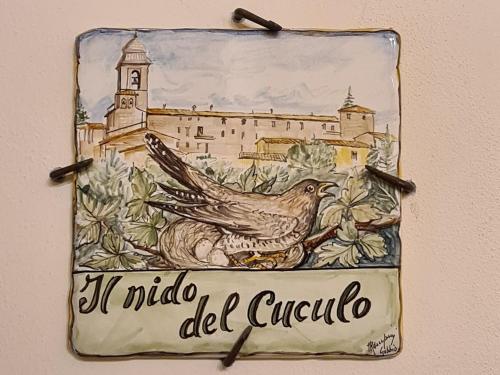 a sign hanging on a wall with a bird at Il Nido del Cuculo in Petrignano