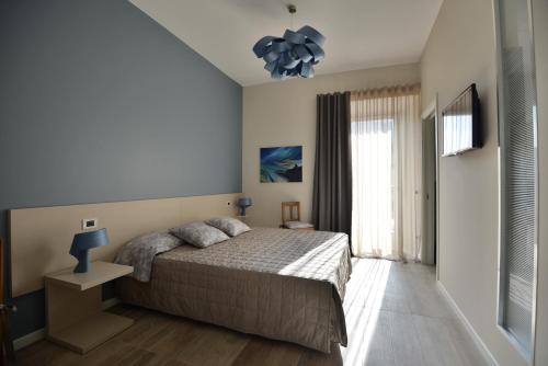 a bedroom with a bed and a television in it at Daman Rooms & Breakfast in Barzago