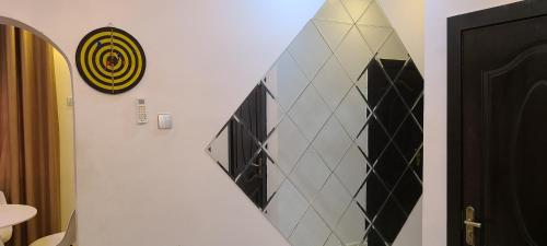 a stairway with a surfboard on a wall at Modern & Cheerful 2 Bedroom Villa, Alagbaka in Akure