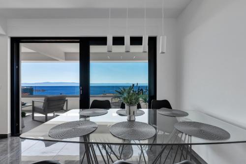 a dining room with a glass table and chairs at Luxury Penthouse Berlin in Makarska