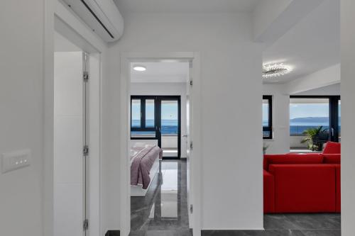 a room with a bed and a red couch at Luxury Penthouse Berlin in Makarska
