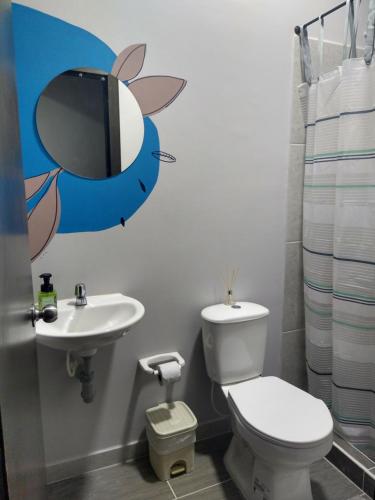 a bathroom with a toilet and a sink at Casa la 15 Pereira in Pereira