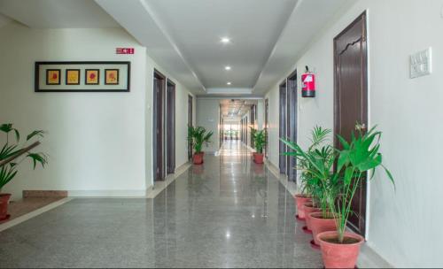 an empty hallway with potted plants in a building at DIDI Hotel Alambagh in Alambagh