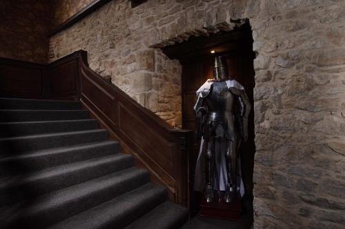 a statue of a knight walking down some stairs at Stone Court House in Maidstone