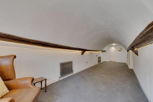 a long hallway with a couch in a room at Stone Court House in Maidstone