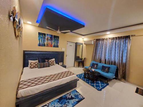 a bedroom with a bed and a blue light at Hotel Mari Aai Residency in Navi Mumbai