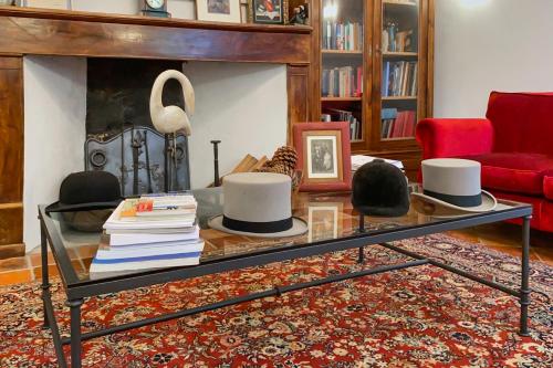 a living room with a glass table with hats on it at Maison Manechal in Monfaucon