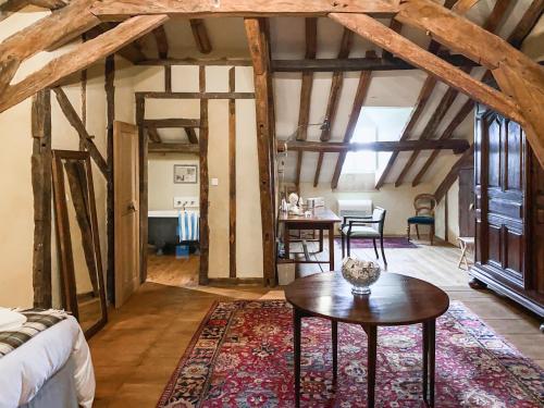 a bedroom with a bed and a table in a room at Maison Manechal in Monfaucon