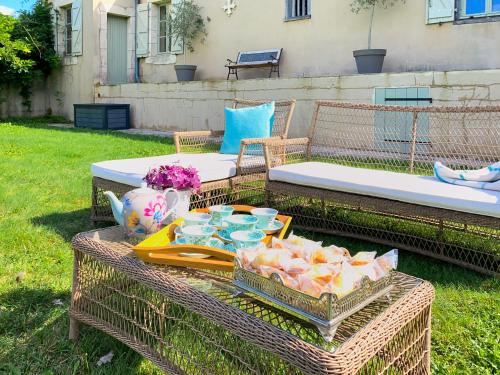 two wicker tables with food on top of them at Maison Manechal in Monfaucon