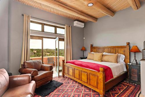 a bedroom with a bed and a chair and a window at 103 B Estrellas de Tano in Santa Fe