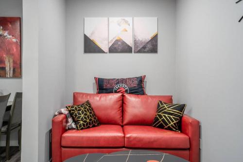 a red leather couch sitting in a living room at Modern & Private 1-Bedroom Apartment in Windsor