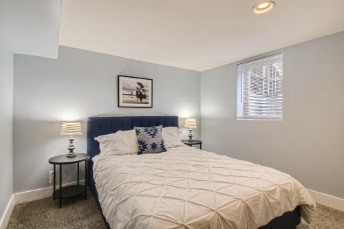 a bedroom with a bed and two tables with lamps at 5602 S Spotswood St in Littleton