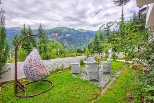 a group of chairs sitting in a yard at Baan by Snow City Farm in Vashisht