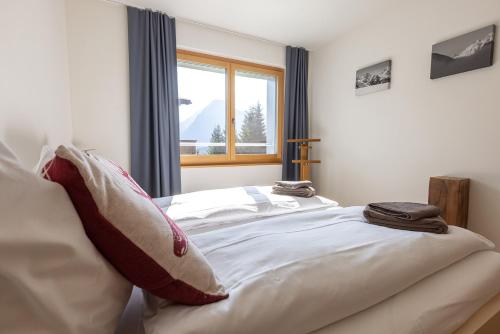 a bedroom with a bed with two pillows on it at Pranursa in Arosa