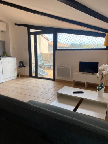 a living room with a couch and a table at Rooftop vue cité médiévale ! in Carcassonne
