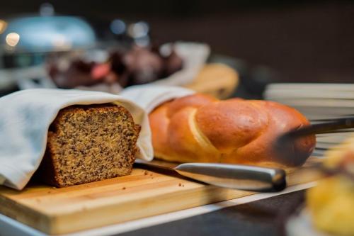 a loaf of bread on a cutting board next to a loaf of bread at Crowne Plaza - Dar Es Salaam by IHG in Dar es Salaam