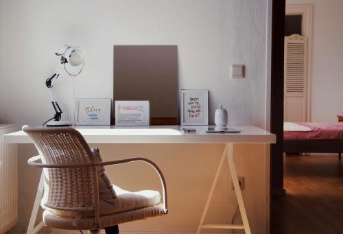 a desk with a chair and a lamp in a room at Ferienhaus Erna in Doberlug-Kirchhain