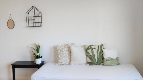 a bedroom with a bed with white sheets and pillows at Ferienhaus Erna in Doberlug-Kirchhain