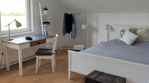a bedroom with a bed with a desk and a bed sidx sidx sidx at Ferienhaus Erna in Doberlug-Kirchhain